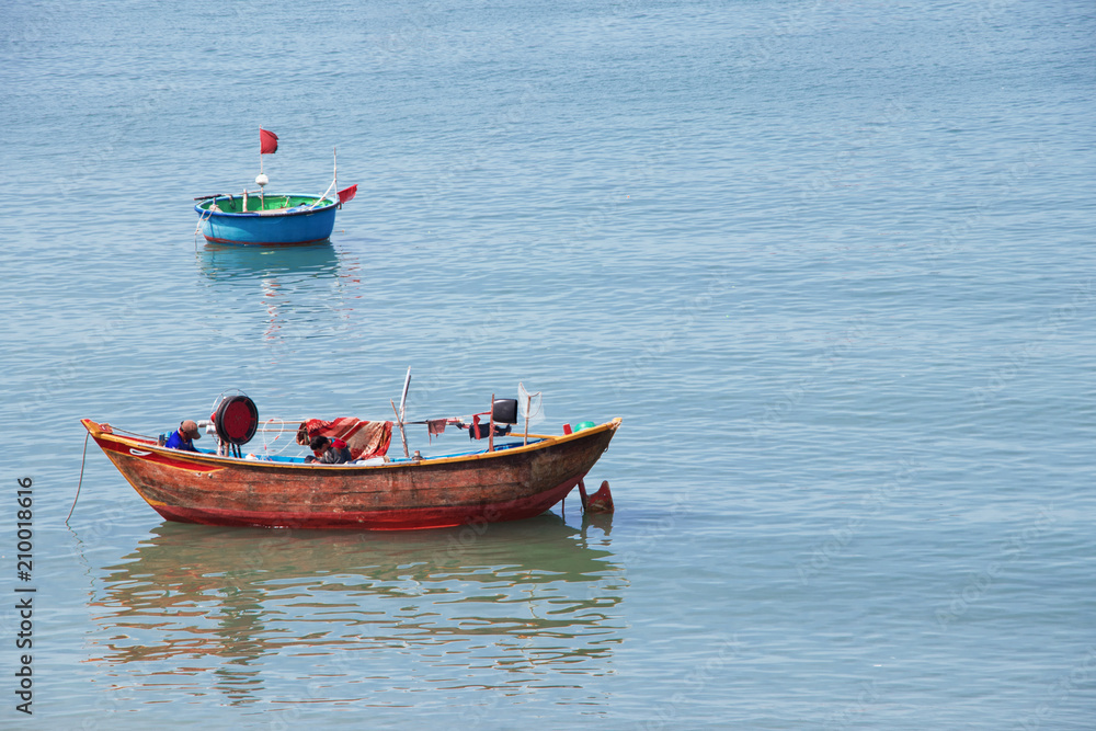 traditional fisher boat with fishermen in vietnam traditional fisher boat with fishermen in vietnam