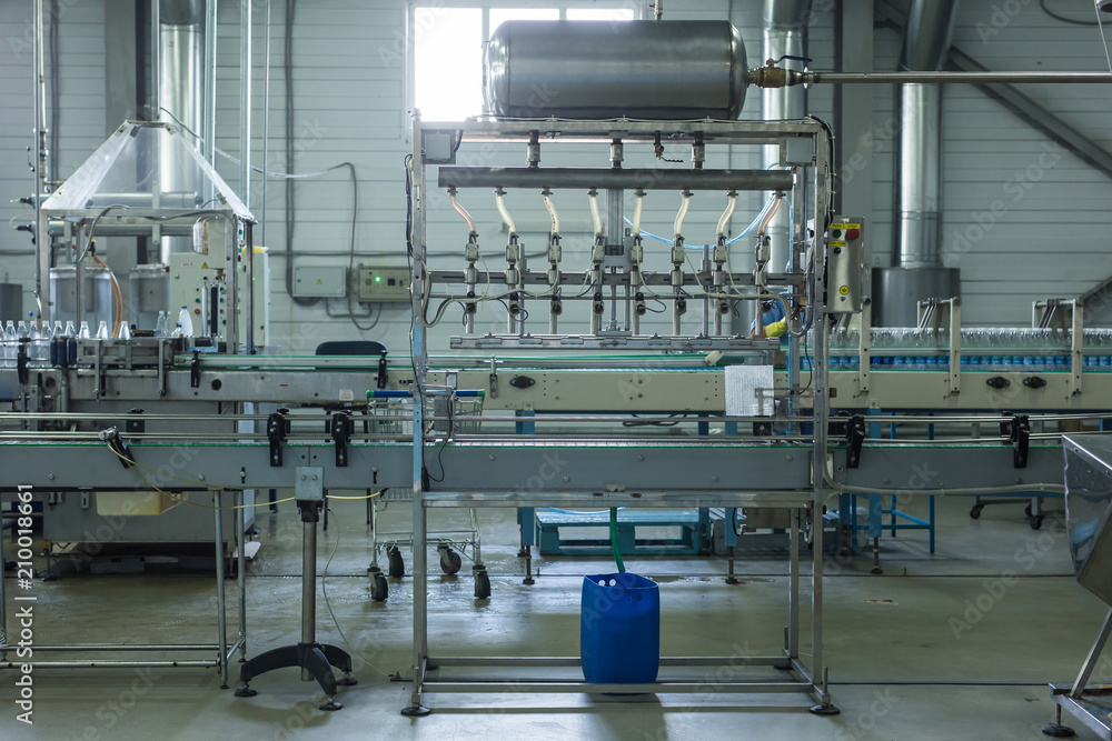 Fototapeta premium Water factory - Water bottling line for processing and bottling pure spring water into small bottles