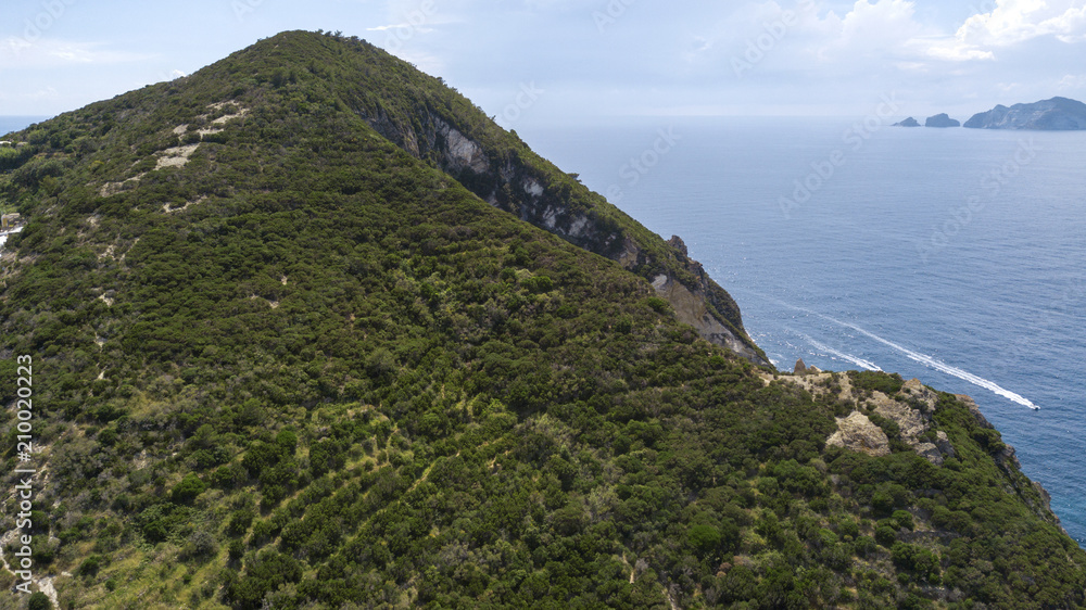 Aerial view of Ponza, island of the Italian Pontine Islands archipelago in the Tyrrhenian Sea, Italy. On the island there are few houses and in the background there is Palmarola.