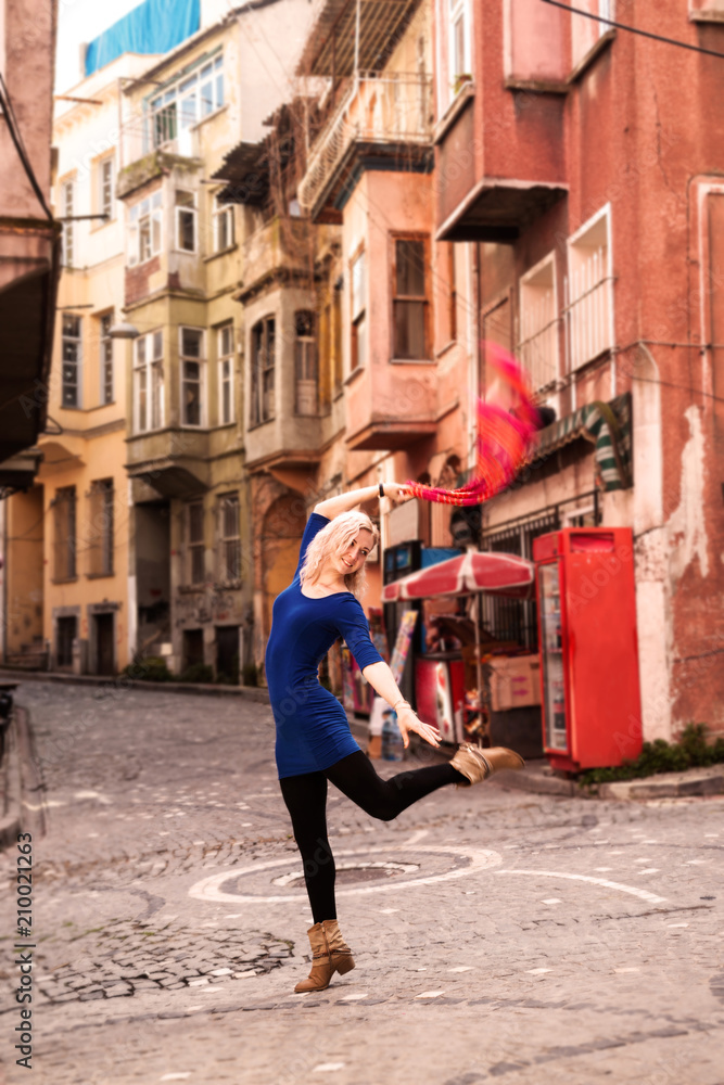 Beautiful girl in front of traditional colorful houses at Balat area. Istanbul
