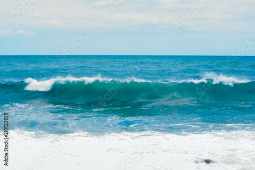 Fototapeta Naklejka Na Ścianę i Meble -  Big breaking Ocean wave on a sandy beach on the north shore of Oahu Hawaii
