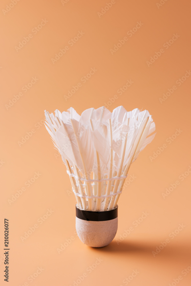 Shuttlecock on a yellow background. Badminton isolated on yellow background Shuttlecock on a yellow background. Badminton isolated on yellow background