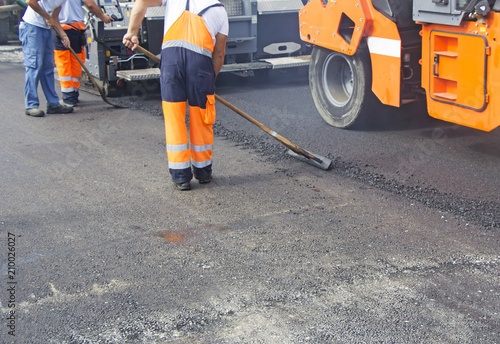 Construction workers on asphalting and road repair
