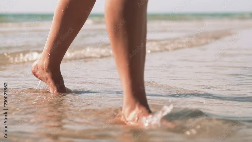 Woman legs coming out of the sea, vacation concept. Slow motion. Woman legs coming out of the sea, vacation concept. Slow motion.