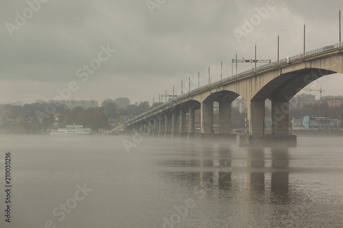 Bridge in the fog over the river