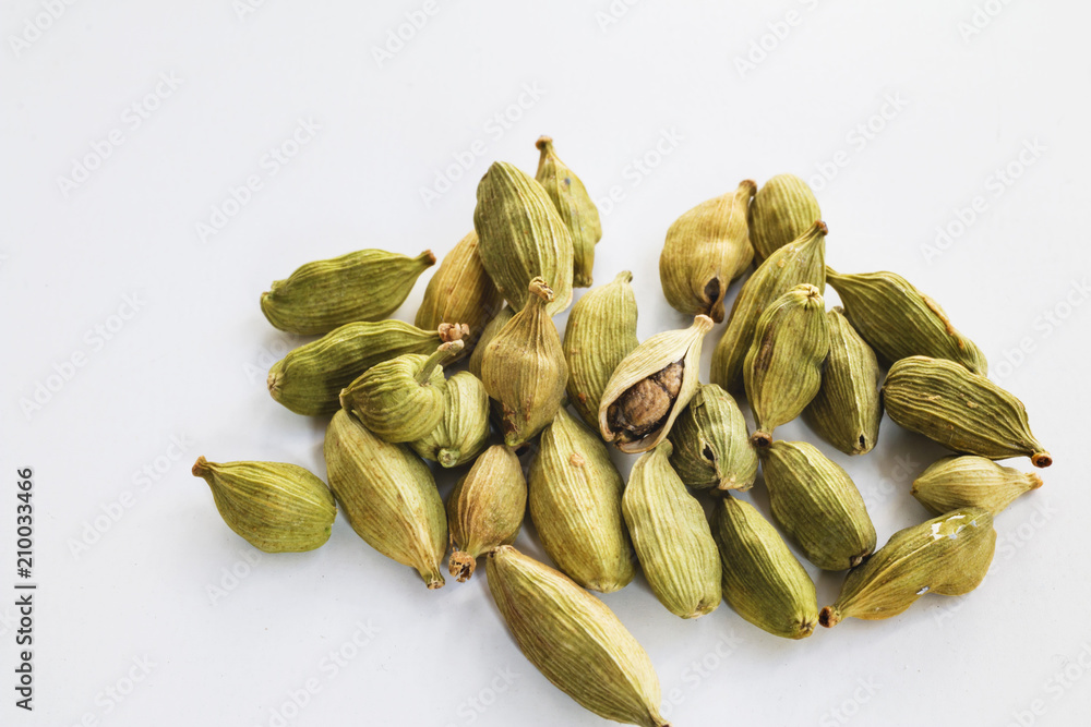 Cardamom seeds on white. Closeup. Macro shot. Cardamom seeds on white. Closeup. Macro shot.