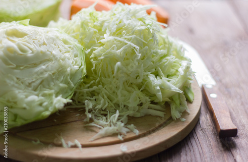 white cabbage cut into strips on a wooden Board for cooking