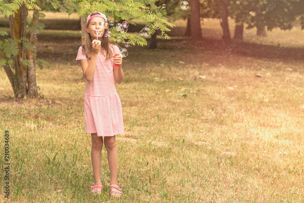 Child girl playing with soap bubbles Child girl playing with soap bubbles