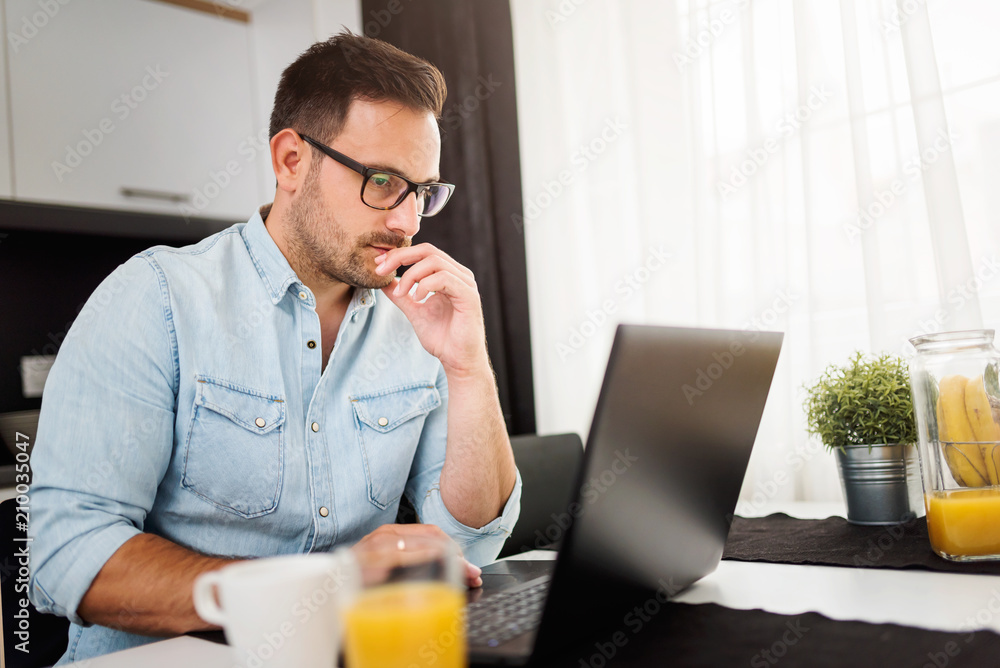 Businessman using laptop computer, working at his hotel room. Traveling for work. Businessman using laptop computer, working at his hotel room. Traveling for work.