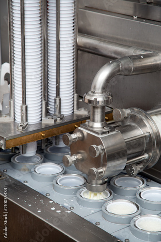 Final Stage Of Production Yogurt-Filling Yogurt Into Plastic Glasses In Modern Dairy