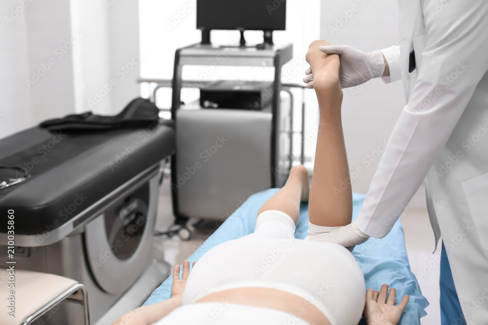 Fototapeta premium Orthopedist examining patient in hospital