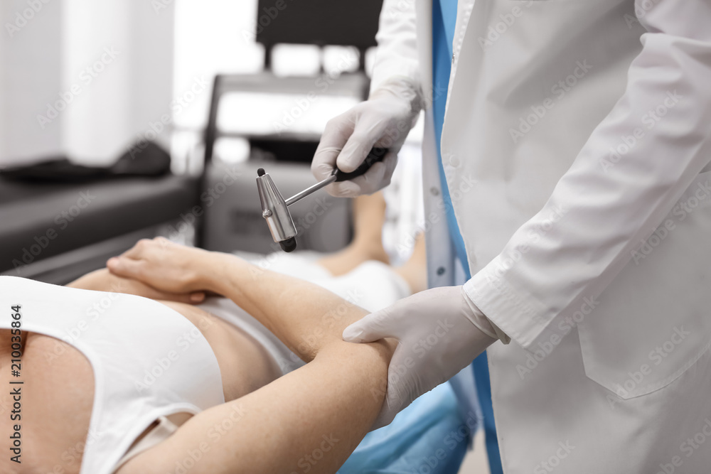 Orthopedist examining patient in hospital Orthopedist examining patient in hospital