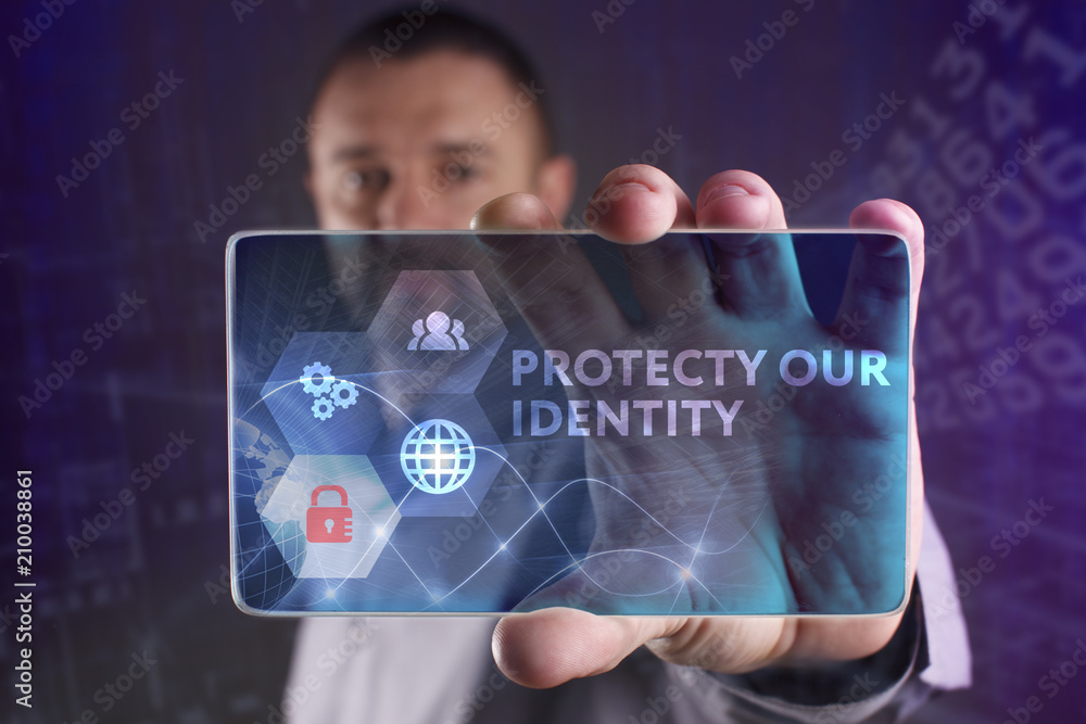 Fototapeta premium The concept of business, technology, the Internet and the network. A young entrepreneur working on a virtual screen of the future and sees the inscription: Protecty our identity