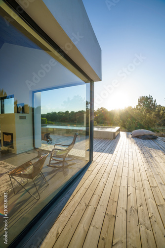 Modern house with garden swimming pool and wooden deck