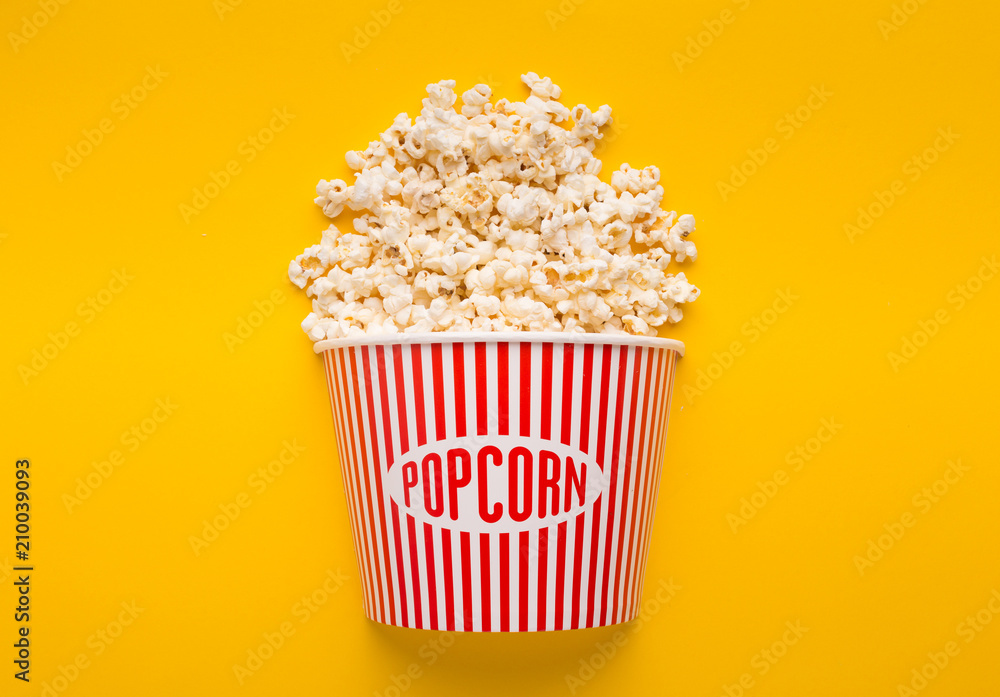 Bucket of popcorn on yellow background