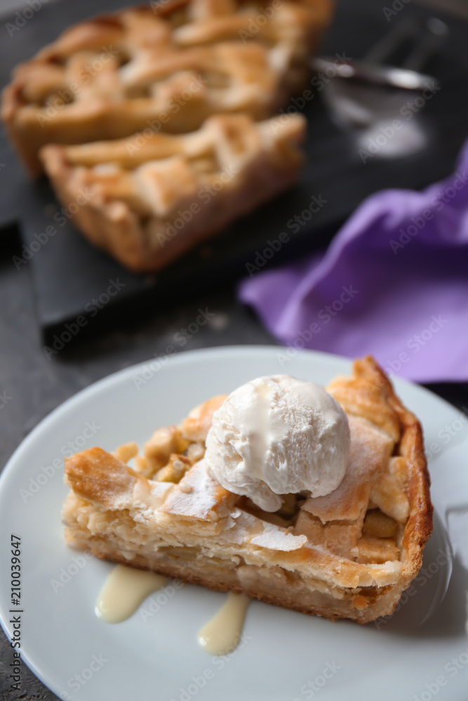 Plate with piece of tasty apple pie and ice-cream on table Plate with piece of tasty apple pie and ice-cream on table