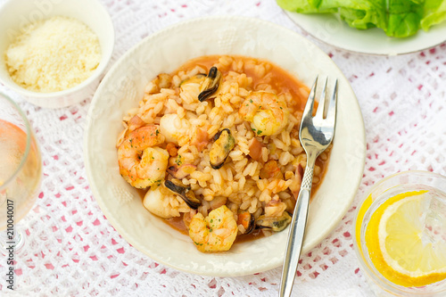 Italian rice dish risotto with seafood, shrimps and mussels