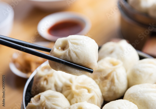 Steamed Xiaolongbao with chopsticks  photo
