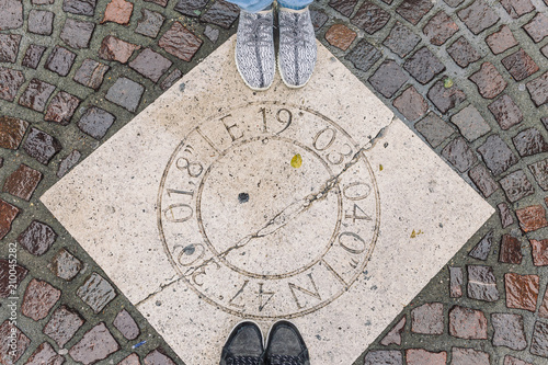 two tourists stand on a beautiful hatch in an old street in the center of Budabest photo