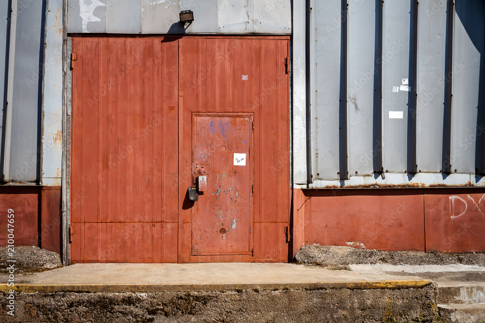 Old metal warehouse door, hangar gate Old metal warehouse door, hangar gate
