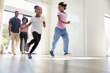 Excited Family Exploring New Home On Moving Day