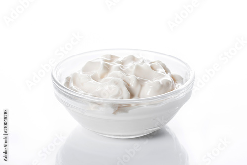 Sour cream in crystal bowl isolated on white background