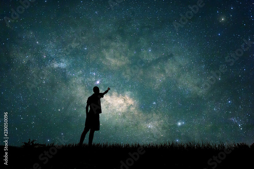 Explorer looking to star on sky at night. Concept astronaut, astronomer, discovery and space study photo