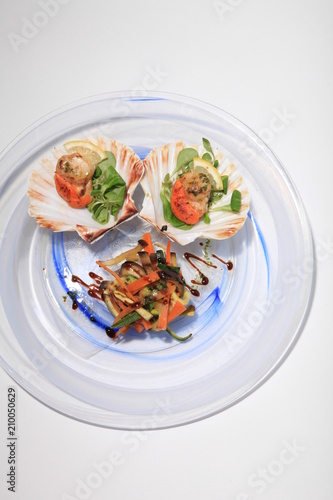 Oysters on a white and blue decorated plate, tasty and healthy