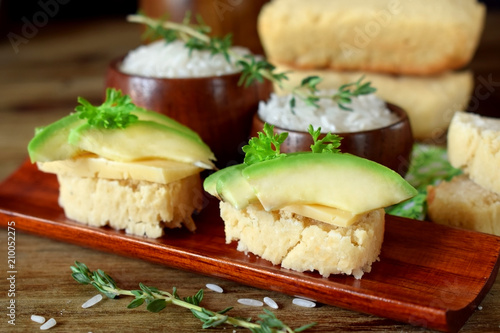 Sandwiches with cheese and avocado slices on pieces of rice gluten free bread