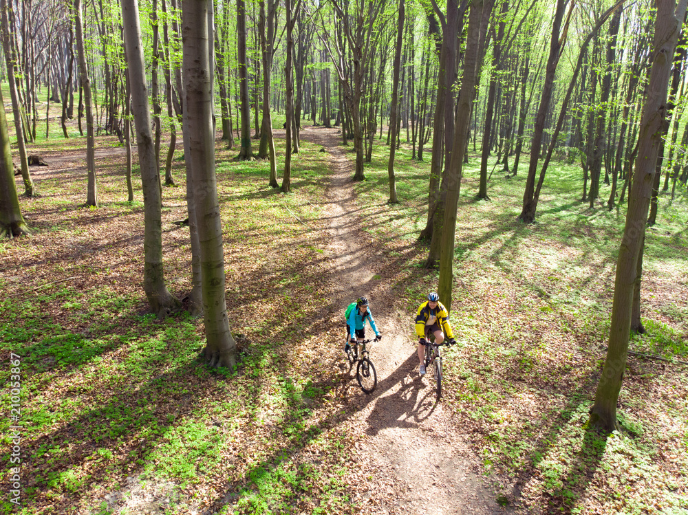 couple riding bicycles in the forest. healthy lifestyle.