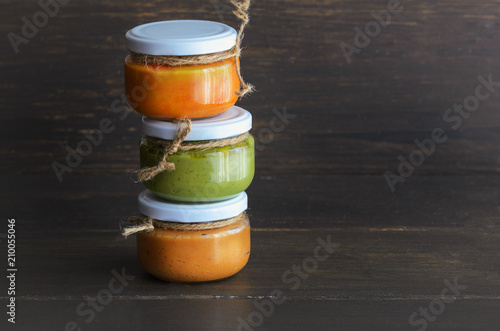 Several types of typical Canary Islands sauces in glass jar: Mojo picon, mojo verde  made and almogrote are popular souvenirs of the fun holiday experience. Copy space photo