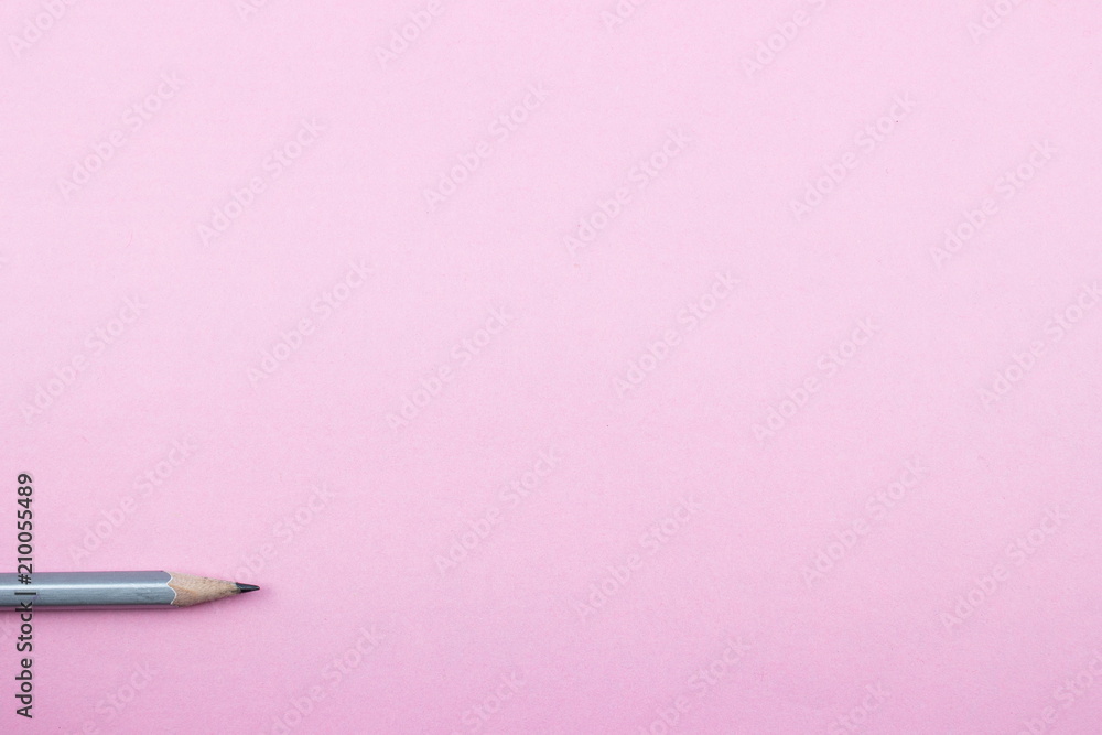 Pencil on rose tone color paper. Empty space for text and design. Minimalism concept Pencil on rose tone color paper. Empty space for text and design. Minimalism concept