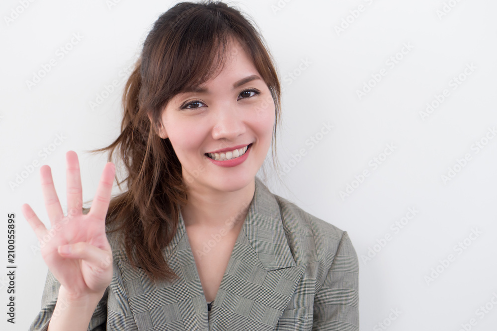 asian business woman pointing four fingers, 4 points; portrait of positive happy smiling asian businesswoman pointing up four fingers, 4 points number; asian chinese adult woman model business theme