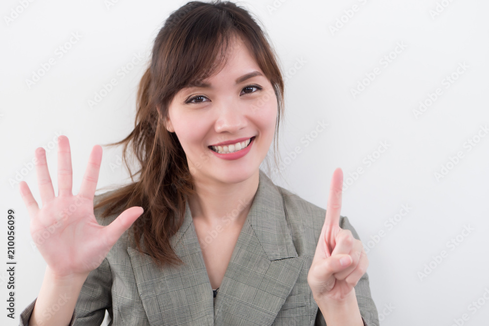 asian business woman pointing six fingers, 6 points; portrait of positive happy smiling asian businesswoman pointing up six fingers, 6 points number; asian chinese adult woman model business theme asian business woman pointing six fingers, 6 points; portrait of positive happy smiling asian businesswoman pointing up six fingers, 6 points number; asian chinese adult woman model business theme