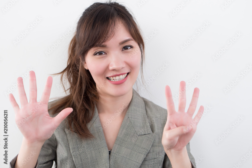 asian business woman pointing nine fingers, 9 points; portrait of positive happy smiling asian businesswoman pointing up nine fingers, 9 points number; asian chinese adult woman model business theme asian business woman pointing nine fingers, 9 points; portrait of positive happy smiling asian businesswoman pointing up nine fingers, 9 points number; asian chinese adult woman model business theme