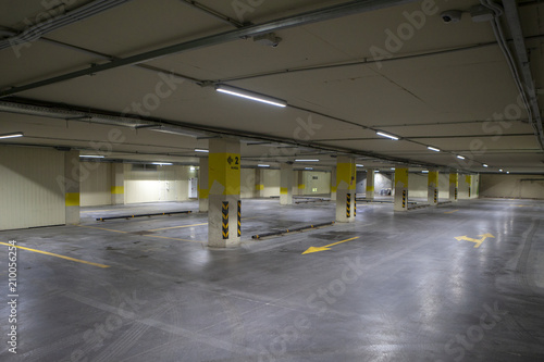 Empty underground parking. Even rows with bright markings.