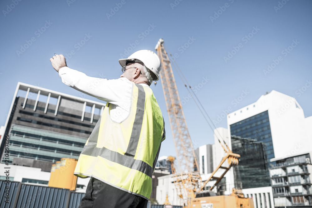 Senior foreman in glasses doing his job at building area on sunn Senior foreman in glasses doing his job at building area on sunn