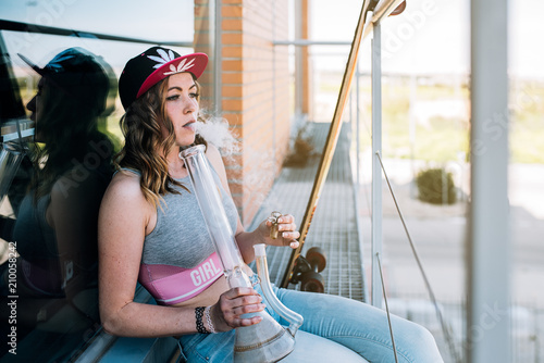Woman smoking marijuana in a bong