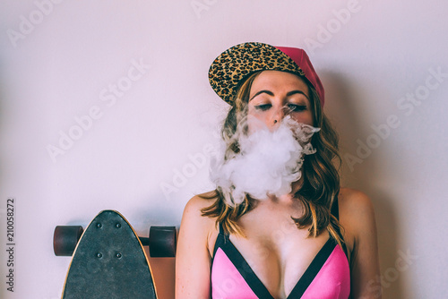 Skater woman smoking a cannabis joint