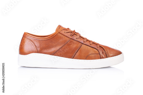Close up of a brown men's sneakers shoes on white background with reflection. Fashion advertising shoes photos.