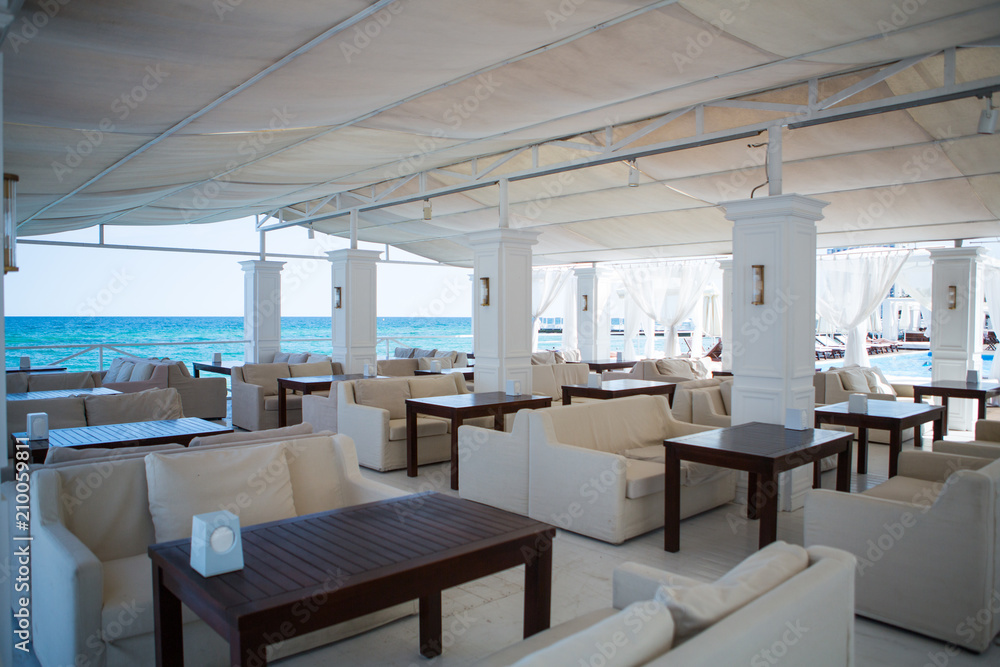 Interior of Elite comfortable beach resort with palm trees and pools. restaurant beach club highest level at resort for holiday in beach season.