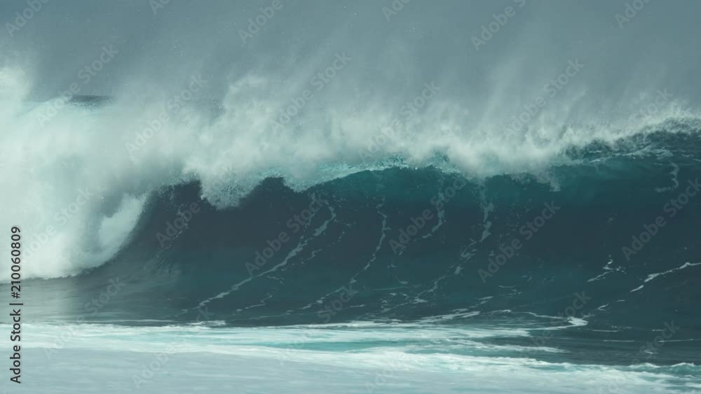 SLOW MOTION, CLOSE UP: Droplets of crystal clear sea water glimmer in the summer sun as epic barrel wave rushes to tropical coast. Breathtaking glassy wave approaching popular surf spot in Chile. SLOW MOTION, CLOSE UP: Droplets of crystal clear sea water glimmer in the summer sun as epic barrel wave rushes to tropical coast. Breathtaking glassy wave approaching popular surf spot in Chile.