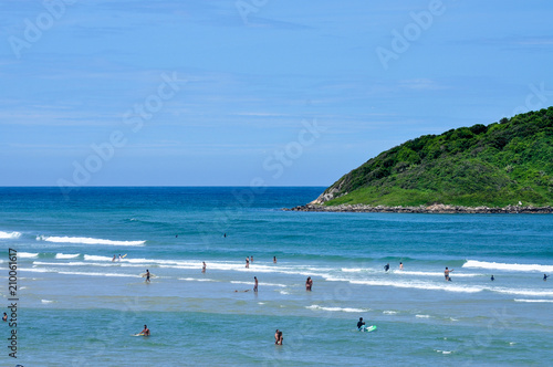  Tourists in the blue sea with green island background photo