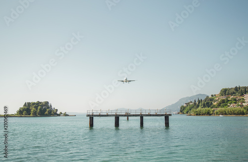 the plane is landing to the airport of Corfu at summer day