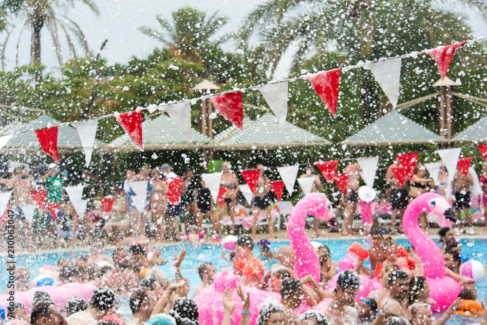 Fototapeta premium Colorful bunting flags on foam party. Selective focus