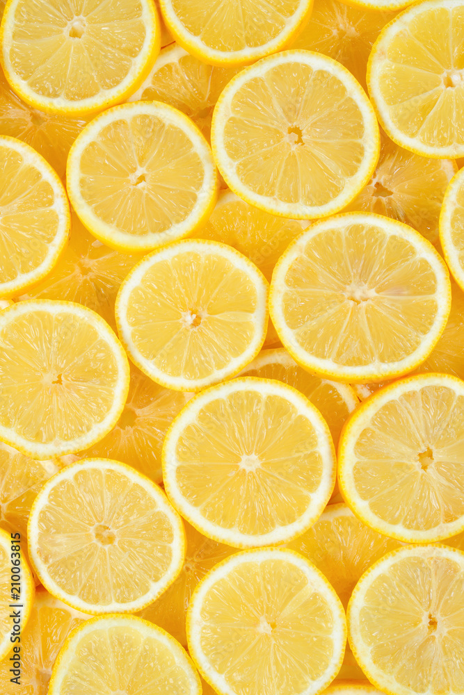 A slices of fresh juicy yellow lemons.  Texture background, pattern