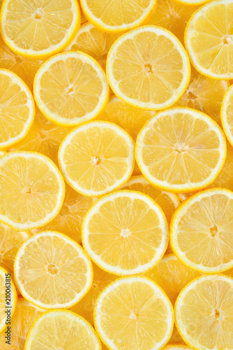 A slices of fresh juicy yellow lemons. Texture background, pattern