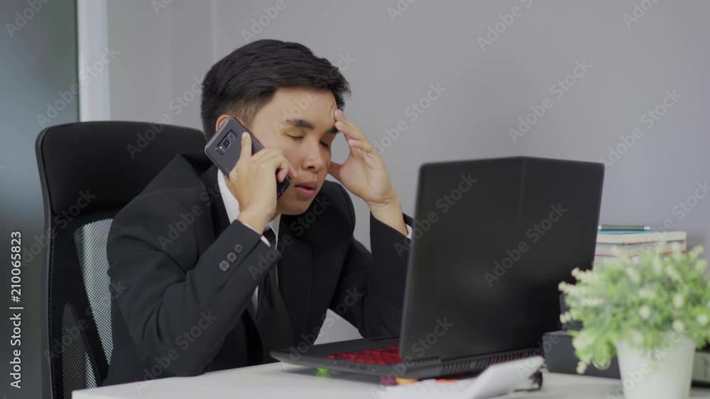 depressed man in suit is talking on smartphone depressed man in suit is talking on smartphone