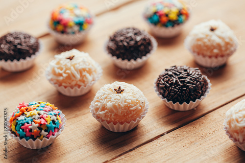 Handmade brazilian sweets: Beijinho and Brigadeiro. Common in children birthday party. Macro, close up photo