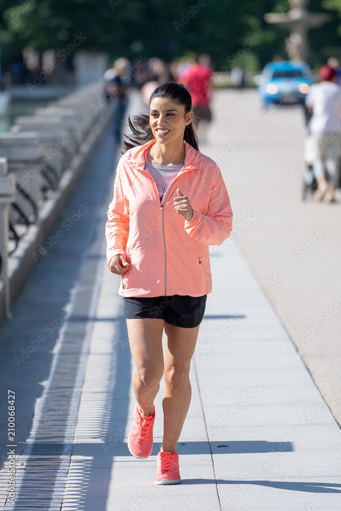 Naklejka premium young attractive happy runner working out in a city party in fitness concept